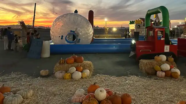 The zorb ball attraction and farm truck under the twilight sky